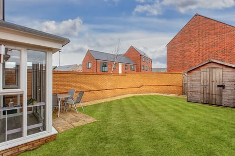 Fully fenced private garden with outdoor seating.
