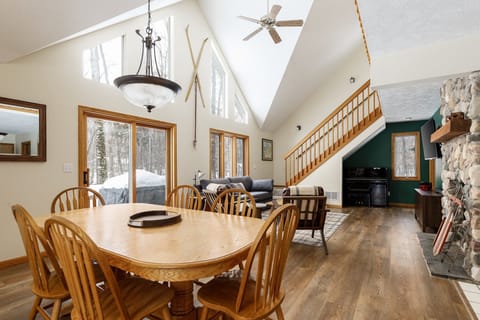 Spacious dining area beneath vaulted ceilings invites long meals & easy conversation.