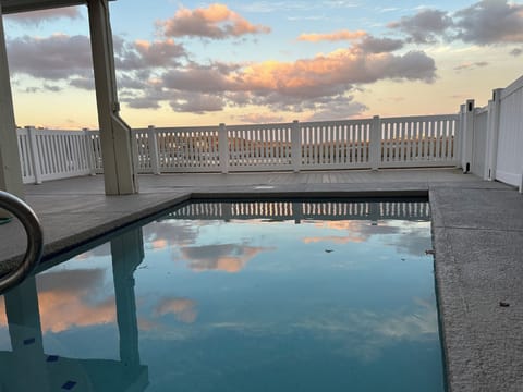 Tranquil poolside with stunning sunset reflections.
