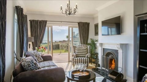 Villa | Living area | TV, fireplace