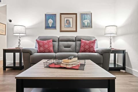Relax in style in this cozy and contemporary living room, featuring a comfortable sofa, elegant lighting, and thoughtfully curated artwork perfect for unwinding after a day of exploring.