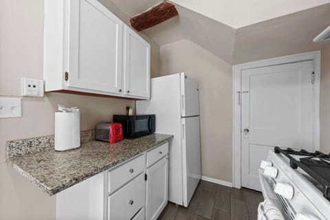 The airy kitchen offers ample space & every home comfort