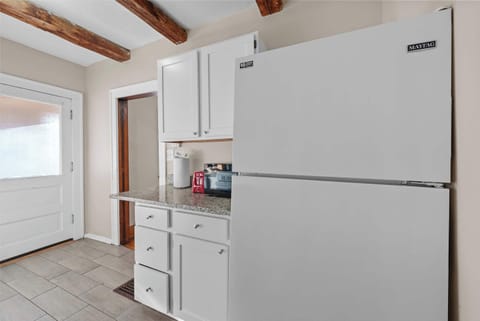 The airy kitchen offers ample space & every home comfort