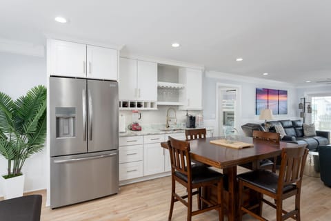 2nd floor living area with pub table, custom leather reclining sofa, 2nd fridge