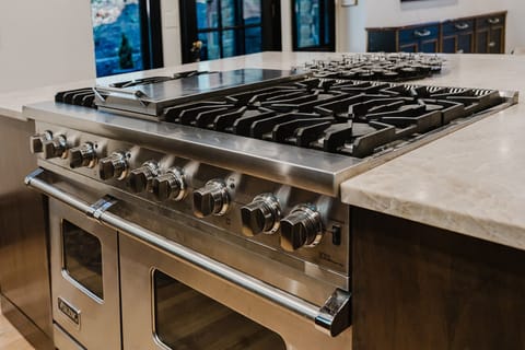 Viking stove ft. double oven, 6 burners, and cast iron skillet