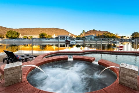 Relax in the hot tub while enjoying breathtaking lake and mountain views