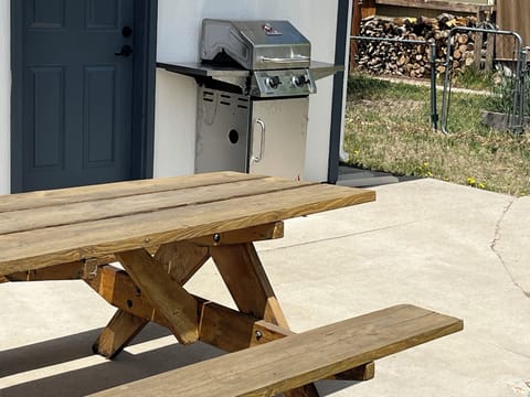 Gas grill and picnic table on private patio
