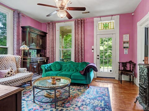 Historic Victorian parlor with original woodwork and curated antiques.