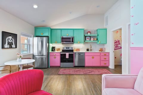 Fully equipped kitchen with all your cooking essentials, drip coffee maker + coffee. Dining table with seating for 2. This room opens up into the living room. Unique colors, wallpaper and decor all throughout the condo.
