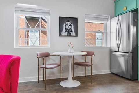 Fully equipped kitchen with all your cooking essentials, drip coffee maker + coffee. Dining table with seating for 2. This room opens up into the living room. Unique colors, wallpaper and decor all throughout the condo.