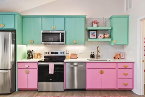 Fully equipped kitchen with all your cooking essentials, drip coffee maker + coffee. Dining table with seating for 2. This room opens up into the living room. Unique colors, wallpaper and decor all throughout the condo.