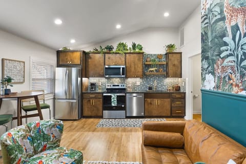 Fully equipped kitchen with all your cooking essentials, drip coffee maker + coffee. Dining table with seating for 2. This room opens up into the living room. Lush, vibrant decor throughout the entire condo!