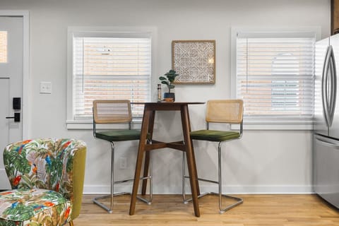 Fully equipped kitchen with all your cooking essentials, drip coffee maker + coffee. Dining table with seating for 2. This room opens up into the living room. Uniquestyle, wallpaper and decor all throughout the condo.