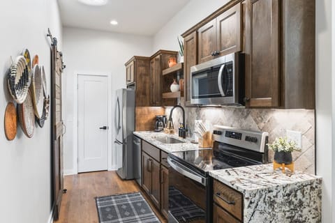Fully equipped kitchen with all your cooking essentials, drip coffee maker + coffee. Dining table with seating for 6. This room opens up into the living room. Unique colors, wallpaper and decor all throughout the condo.