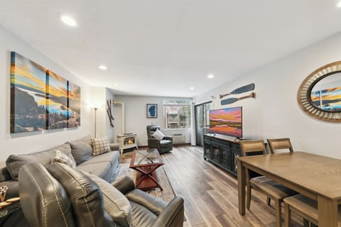 Your modern open-concept space combines comfort and style with cozy seating, mountain artwork, and a warm fireplace for memorable evenings.