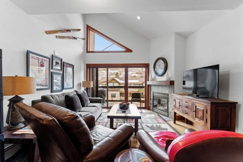 Sink into plush leather seating by the warm fireplace, where mountain views frame your perfect alpine retreat.