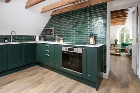The Hayloft, Kailzie - stylish kitchen with sleek subway tiles and sitting room beyond