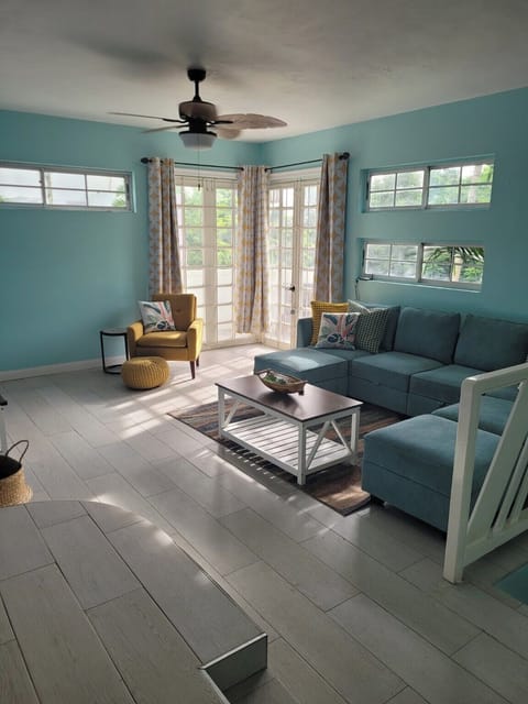 Bright, airy living space with tropical views just beyond the French doors.