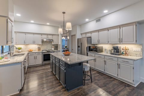 Modern and well equipped kitchen has both Keurig and drip coffee makers.