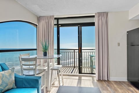 Wake up to the invigorating glow of natural light filling this beautifully designed living and dining area. From dawn to dusk, enjoy unforgettable breathtaking ocean and resort views. This unique condo in North Myrtle Beach is an exceptional getaway.