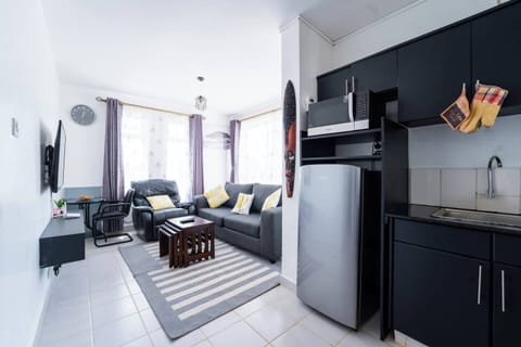 A view of the apartment from the entrance, You can view the sitting room area with a fully equipped dedicated workspace area and a 49inch Hd Tv.
