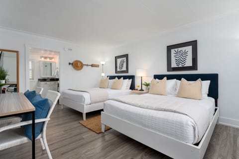 Two comfortable queen beds with premium linens and plush pillows.