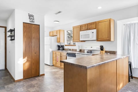 The open, airy kitchen offers ample space & every home comfort