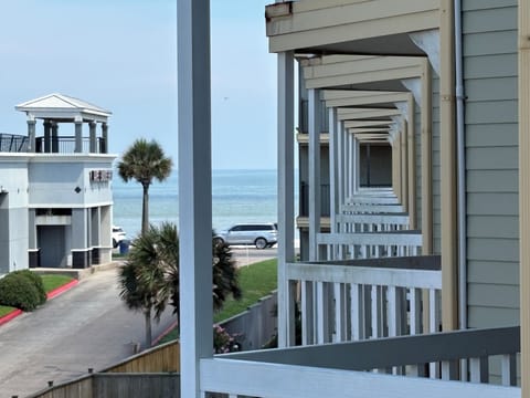 Partial ocean-view balcony with palm-lined coastal charm