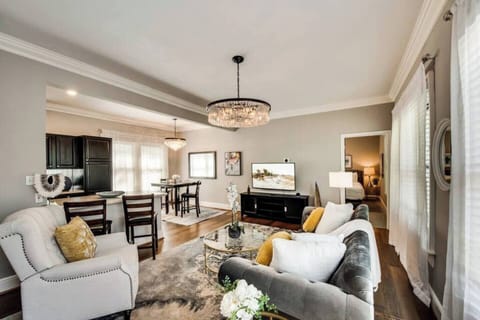 A comfortable living room blending modern elegance, featuring a 55" smart TV for the perfect space to relax and unwind.