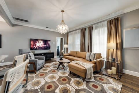 A comfortable living room blending modern elegance, featuring a 65" smart TV for the perfect space to relax and unwind.