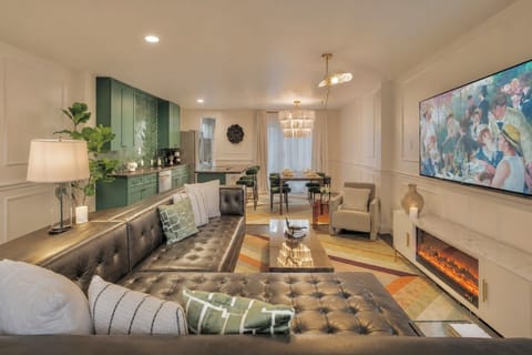 Spacious living room with a roomy leather sectional and plenty of seating, plus a 65" Smart TV for ultimate relaxation and entertainment.