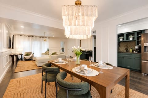 Open dining area with seating for four, featuring a beautiful chandelier..