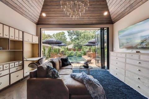 Enjoy stunning views of your private pool from this expansive primary bedroom. Relax in comfort with a large TV, perfect for watching your favorite shows or a movie.