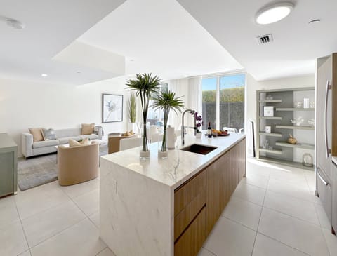 Modern Kitchen | Floor to ceiling windows illuminate the open-concept living area.