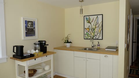 Kitchenette with microwave, kettle, coffee maker, toaster oven, induction stove