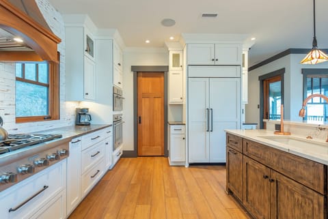 Gourmet kitchen dishwasher, gas range, and drip-style coffee maker.