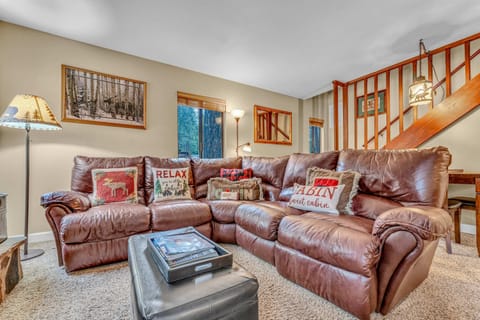 Living Room: Main floor, wood-burning fireplace, Smart TV, Apple TV, sectional seating