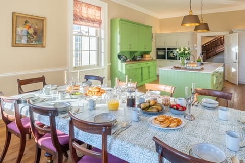 The colourful well-equipped kitchen is complete with a dining table