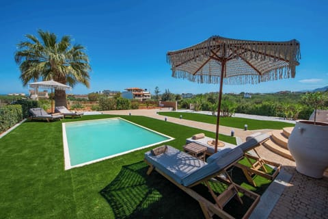Poolside Relaxation Area with Umbrella and Garden Views