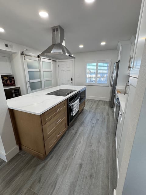 Kitchen with island and enclosed laundry