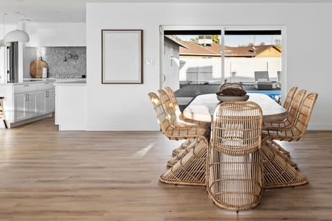 Light-filled dining area with woven chairs and an inviting open layout.
