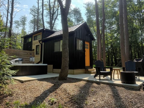 Whitman exterior with hot tub — personal hot tub on the patio, Adirondack seating, wooded setting