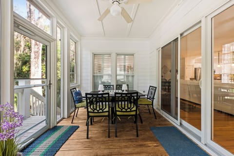 Dine outdoors in comfort on the peaceful Screened Porch / Outdoor Dining area.