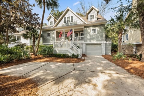 Welcome home! This charming Lowcountry beach house offers a sunny, inviting front porch and classic coastal style.