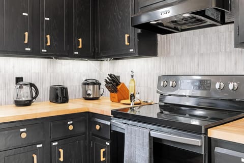 Closer look at toaster, electrical kettle, and rice cooker in full kitchen