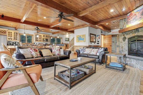 Inviting living area with high ceilings, fireplace, and plenty of seating for family gatherings.