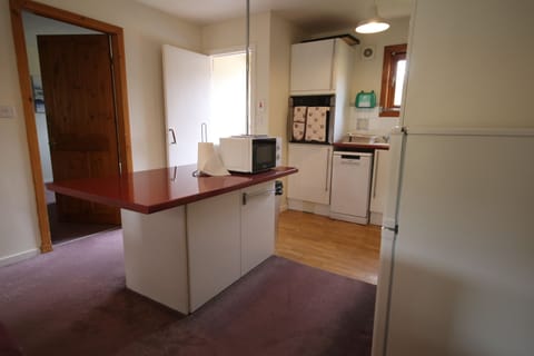 Kitchen showing front door and door to lounge