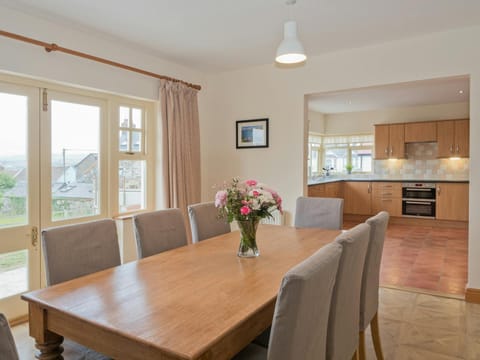Dining room leading to kitchen with electric hob and oven