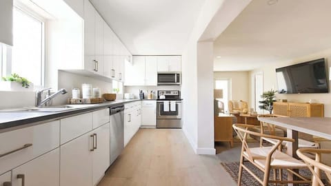 Cook with ease in a fully stocked kitchen featuring modern appliances.