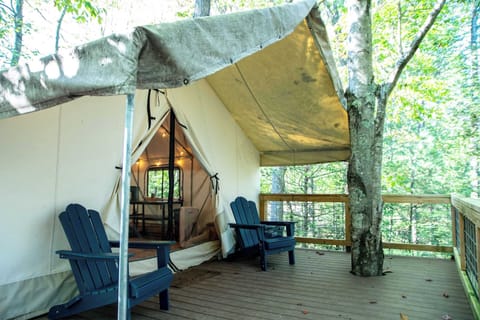 Enjoy views of the forest on your covered porch and private sitting area! Equipped with two Adirondack chairs and a large RTIC cooler. 
